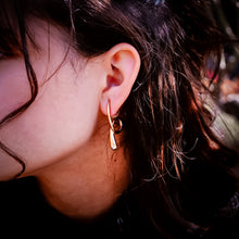 Load image into Gallery viewer, Teuila Fatupaito Flux Studs in 18k gold plated stainless steel, side angle view showing 3D form and texture on model