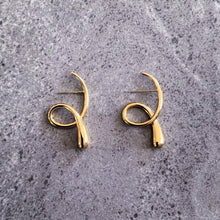 Load image into Gallery viewer, Teuila Fatupaito Flux Studs in 18k gold plated stainless steel, close-up detail of minimalist flowing curves