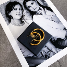 Load image into Gallery viewer, Teuila Fatupaito Hollow C-Shaped Hoops in 18K gold PVD plated stainless steel, close-up detail of the hollow construction and gold finish. showing branding and logo