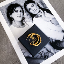 Load image into Gallery viewer, Model wearing Teuila Fatupaito Twisted Hoops, showcasing how these gold-plated twisted earrings complement facial features and company branding.