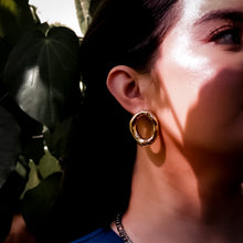 Load image into Gallery viewer, Close-up of a model wearing a gold hoop earring - Teuila Fatupaito