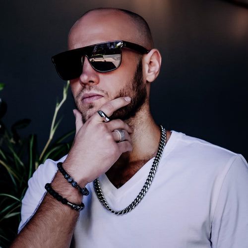 Model wearing Cuban link chain by Teuila Fatupaito and sunglasses