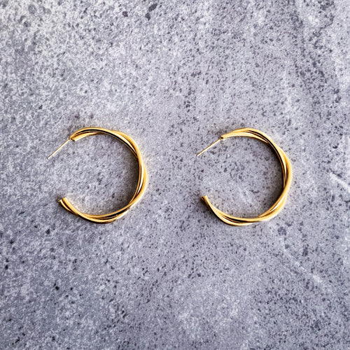 Teuila Fatupaito Twisted Hoops in 18K gold PVD plated stainless steel, front view showing unique twisted design
