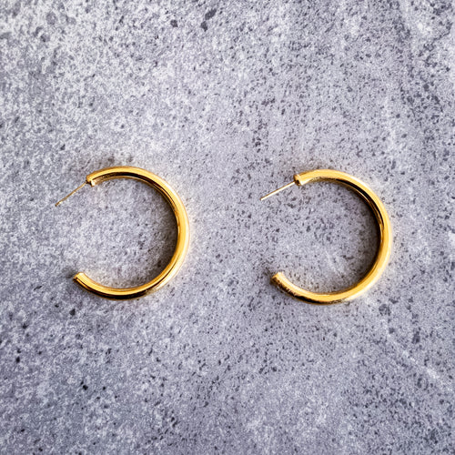 Teuila Fatupaito Hollow C-Shaped Hoops in 18K gold PVD plated stainless steel, front view showing elegant curved design
