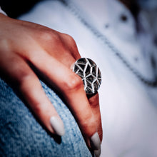 Load image into Gallery viewer, Close-up of a hand wearing a Teuila Fatupaito geometric silver ring with a blurred background

