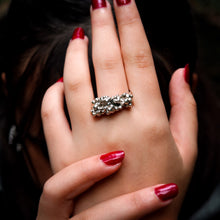 Load image into Gallery viewer, Close-up of a hand wearing a Teuila Fatupaito silver ring with red nail polish.
